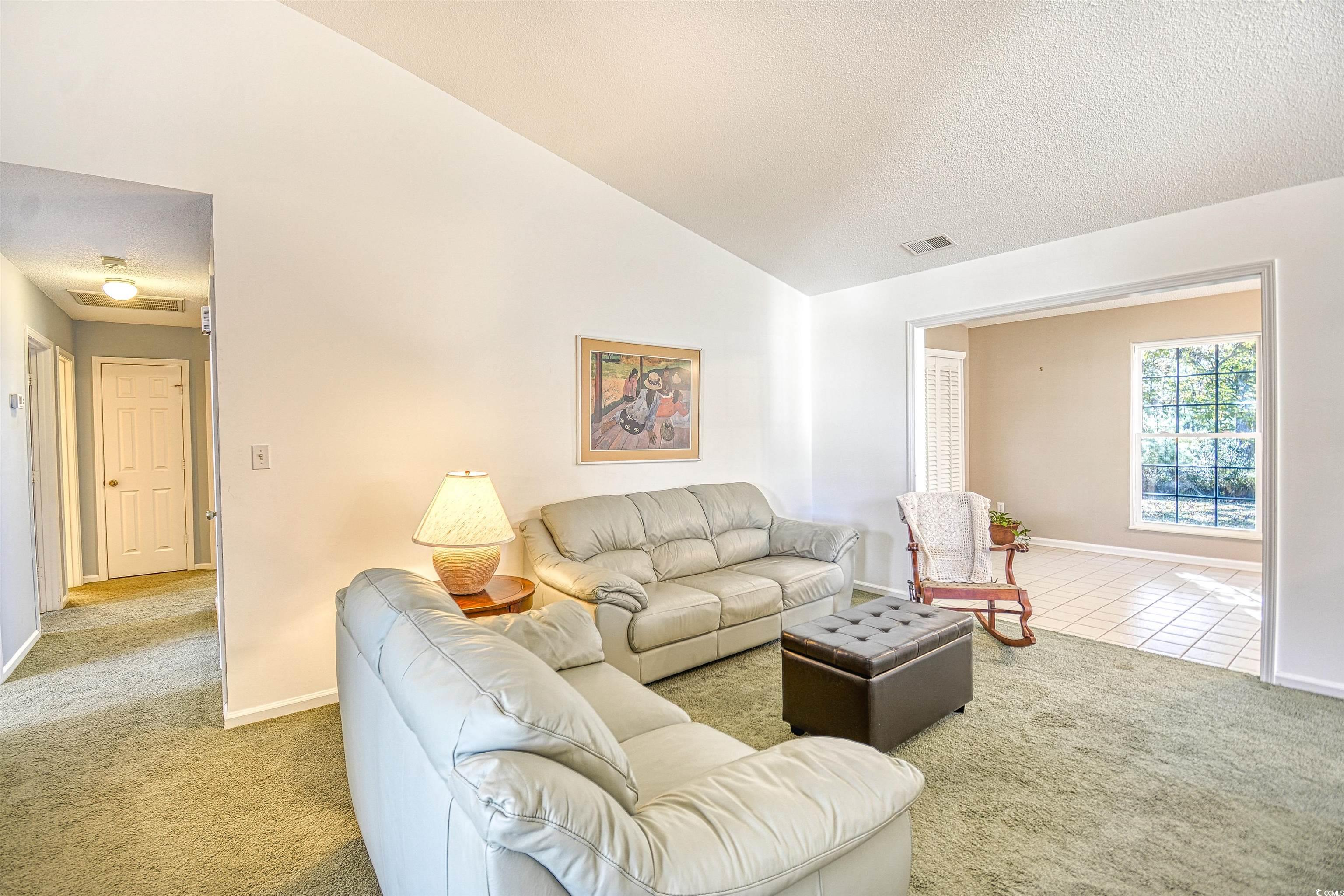 651 Bluebird Lane Murrells Inlet, SC 29576 - Photo 3 of 34 Living room featuring lofted ceiling, light colore