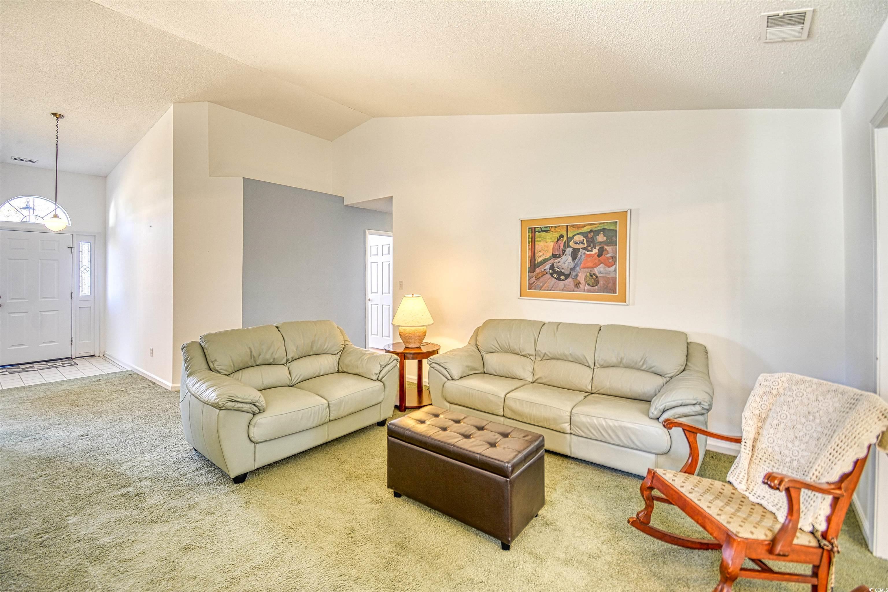 651 Bluebird Lane Murrells Inlet, SC 29576 - Photo 4 of 34 Carpeted living room featuring a textured ceiling