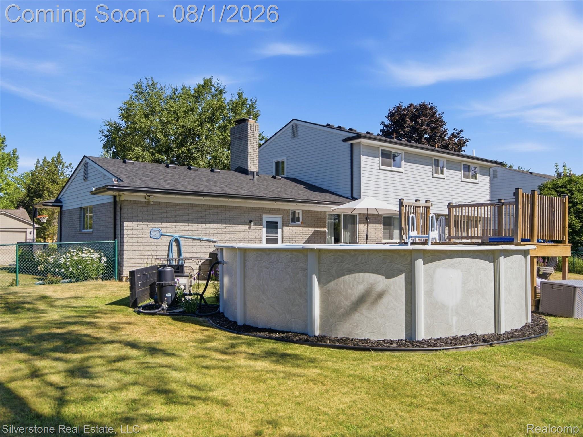 2135 Wayward Drive Rochester, MI 48309 - Photo 49 of 55 Expansive backyard featuring an above-ground pool, a spacious wood deck, and a manicured lawn