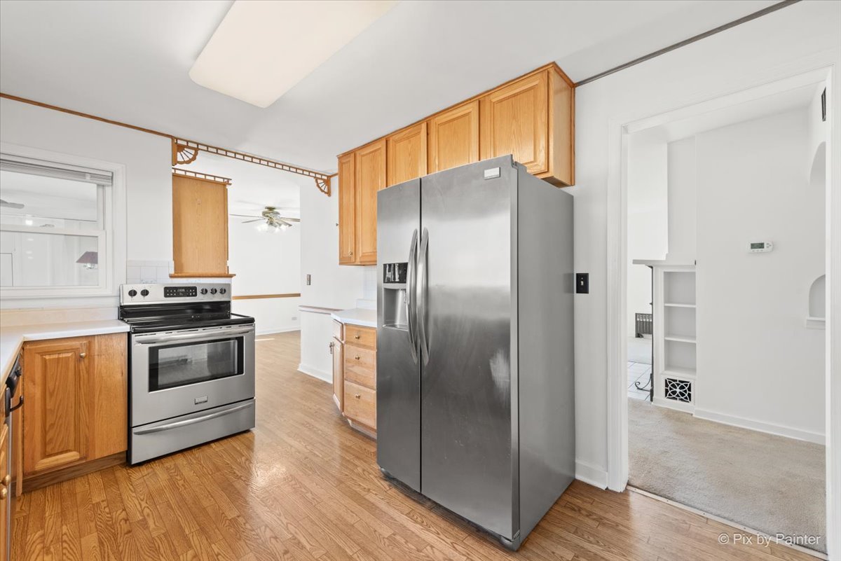 1106 West Highland Avenue Elgin, IL 60123 - Photo 11 of 47 a kitchen with granite countertop a refrigerator and a stove top oven