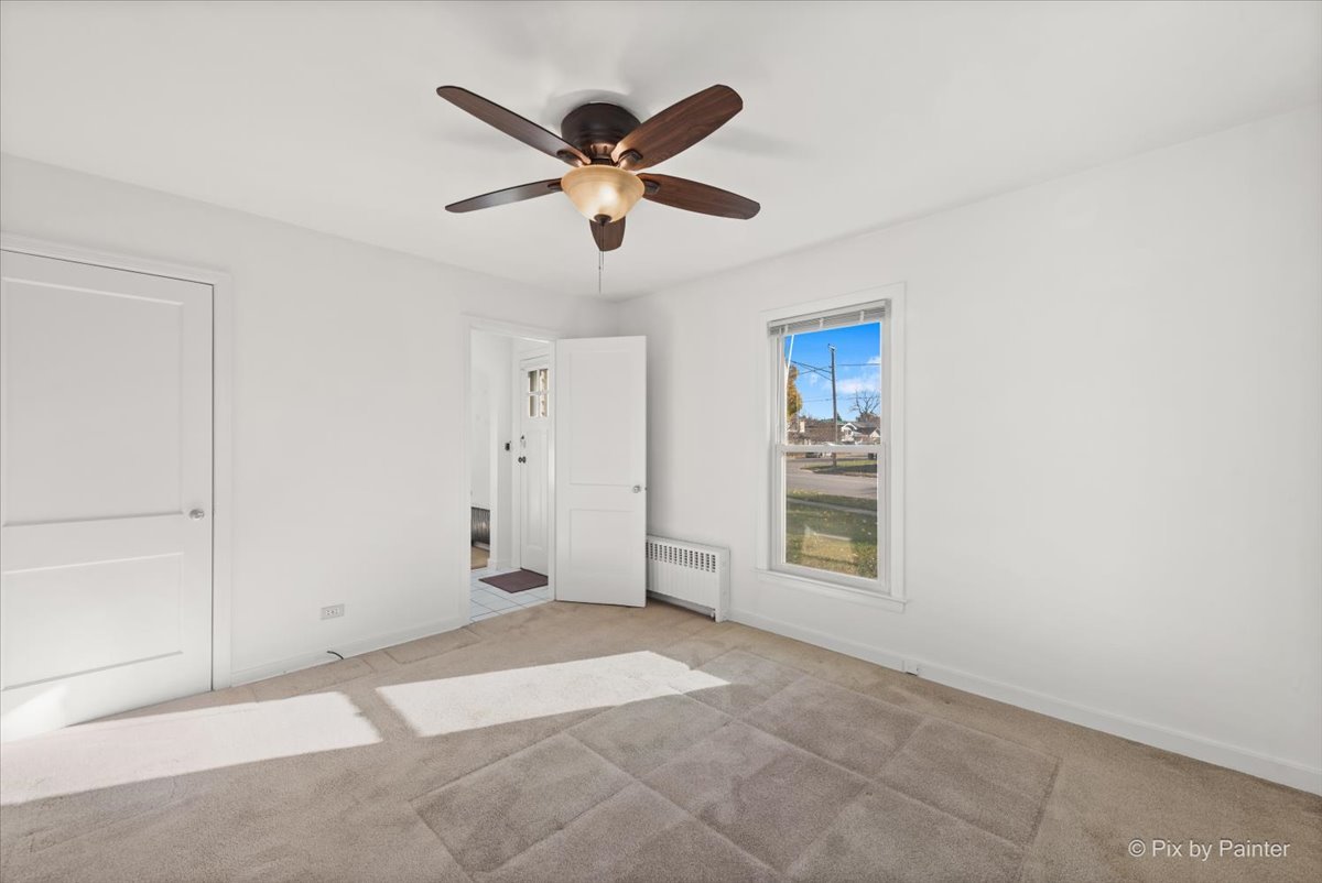 1106 West Highland Avenue Elgin, IL 60123 - Photo 20 of 47 a view of a livingroom with a ceiling fan and window