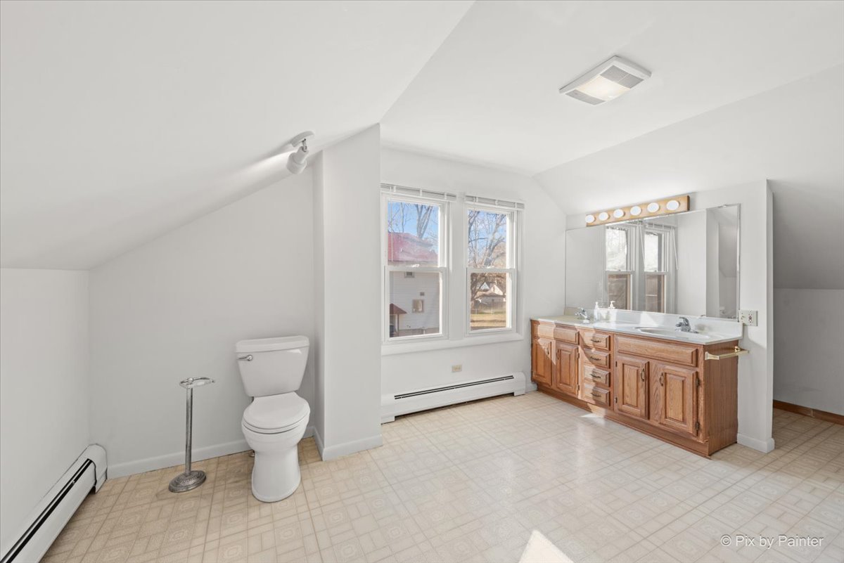 1106 West Highland Avenue Elgin, IL 60123 - Photo 21 of 47 a room with a chair and ceiling fan