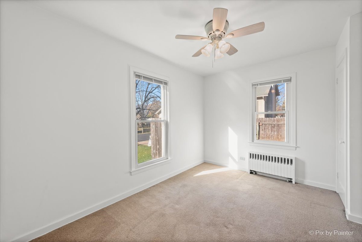 1106 West Highland Avenue Elgin, IL 60123 - Photo 26 of 47 an empty room with windows and fan