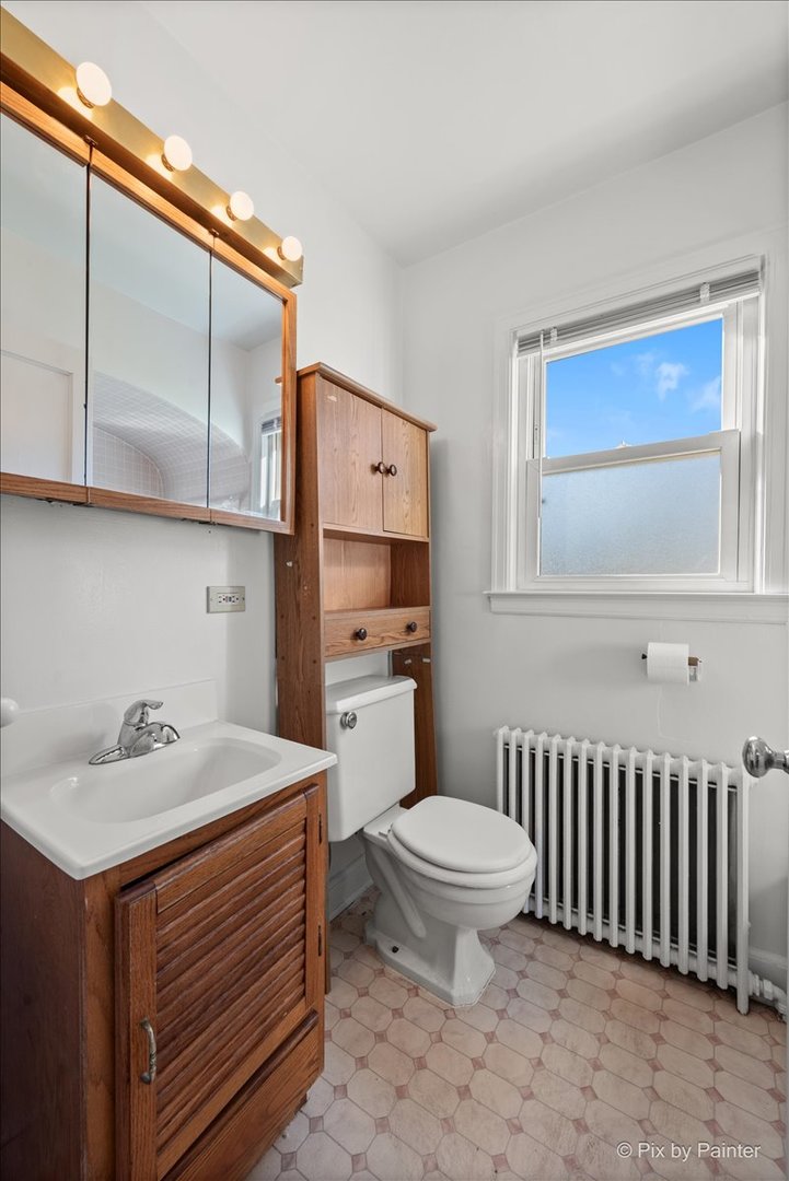 1106 West Highland Avenue Elgin, IL 60123 - Photo 28 of 47 a bathroom with a sink toilet and shower