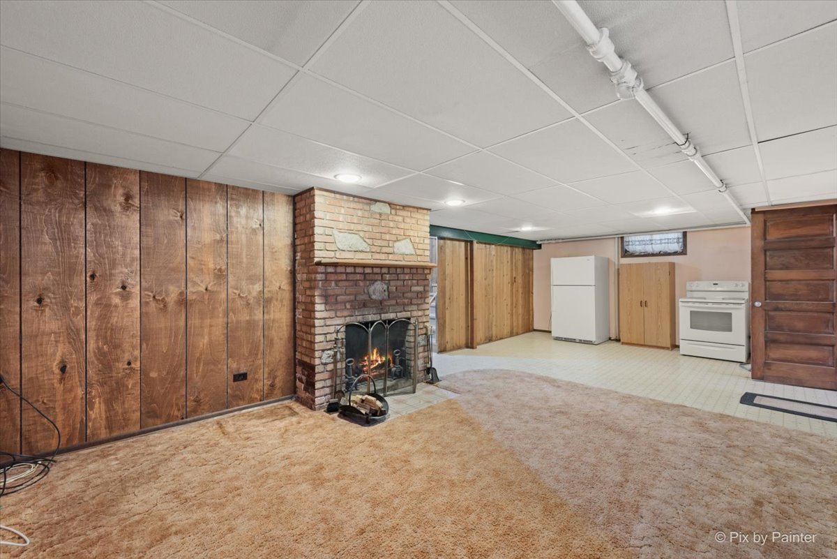1106 West Highland Avenue Elgin, IL 60123 - Photo 30 of 47 an empty room with furniture and a fireplace