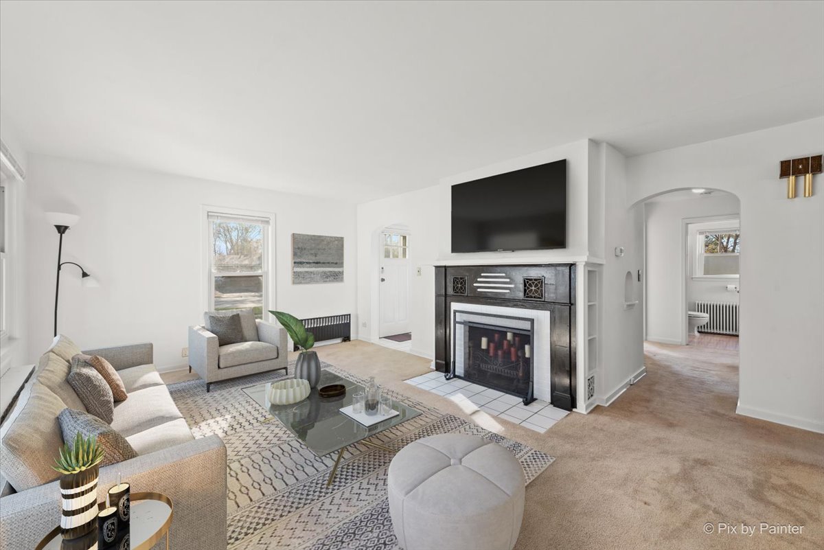 1106 West Highland Avenue Elgin, IL 60123 - Photo 5 of 47 a living room with furniture a flat screen tv and a fireplace