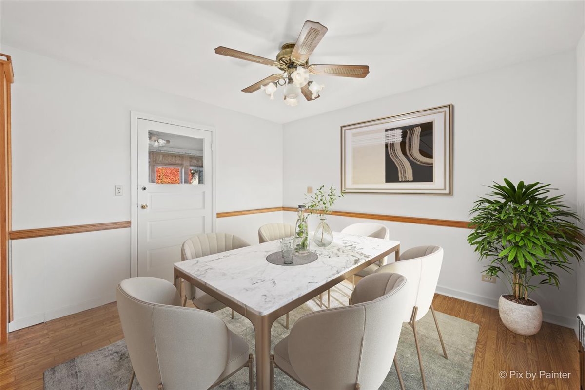 1106 West Highland Avenue Elgin, IL 60123 - Photo 6 of 47 a view of a dining room with furniture and wooden floor