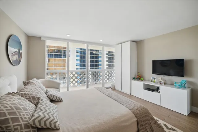 a bedroom with a bed and a flat screen tv