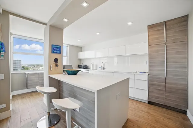 a kitchen with a sink cabinets and wooden floor