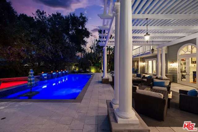 a swimming pool with outdoor seating and yard