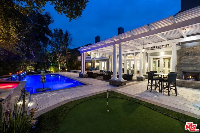 a room with stainless steel appliances granite countertop sink and wooden cabinets