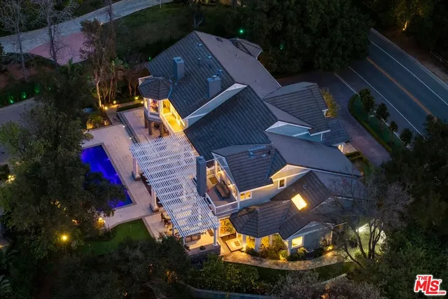 an aerial view of house with yard swimming pool and outdoor seating