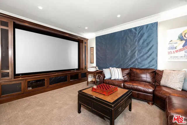 a living room with a bed and a large window