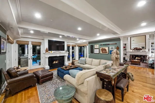 a living room with fireplace furniture and a wooden floor