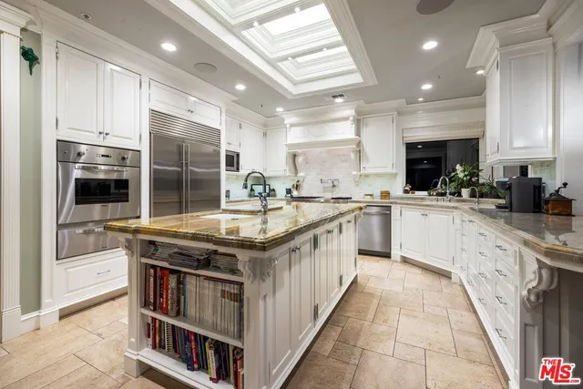 a kitchen with stainless steel appliances granite countertop a stove and a sink
