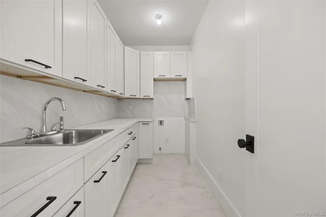 a view of an empty room with a fireplace and a window