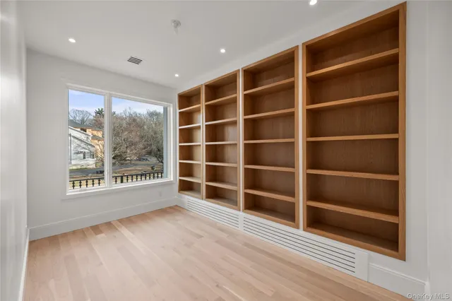 a view of a livingroom with wooden floor and a window
