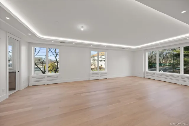 a large white kitchen with cabinets