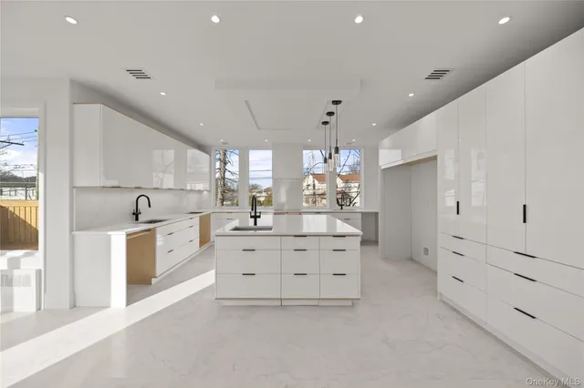 a large white room with lot of white cabinets