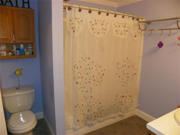 14 Shawnee Road Pepperell, MA 01463 - Photo 8 of 13 a bathroom with a toilet and a shower curtain