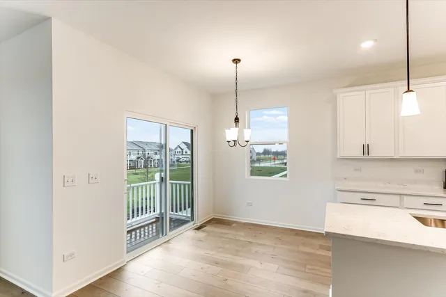 a view of a kitchen with a stove and white cabinets