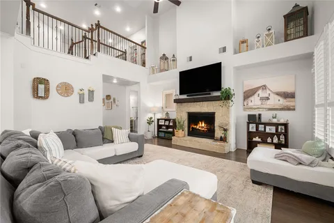 a living room with furniture fireplace and flat screen tv