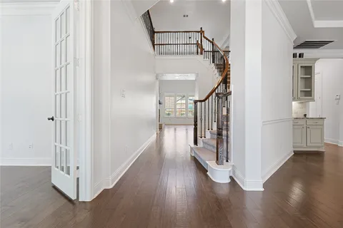 a view of hallway with stairs and wooden floor