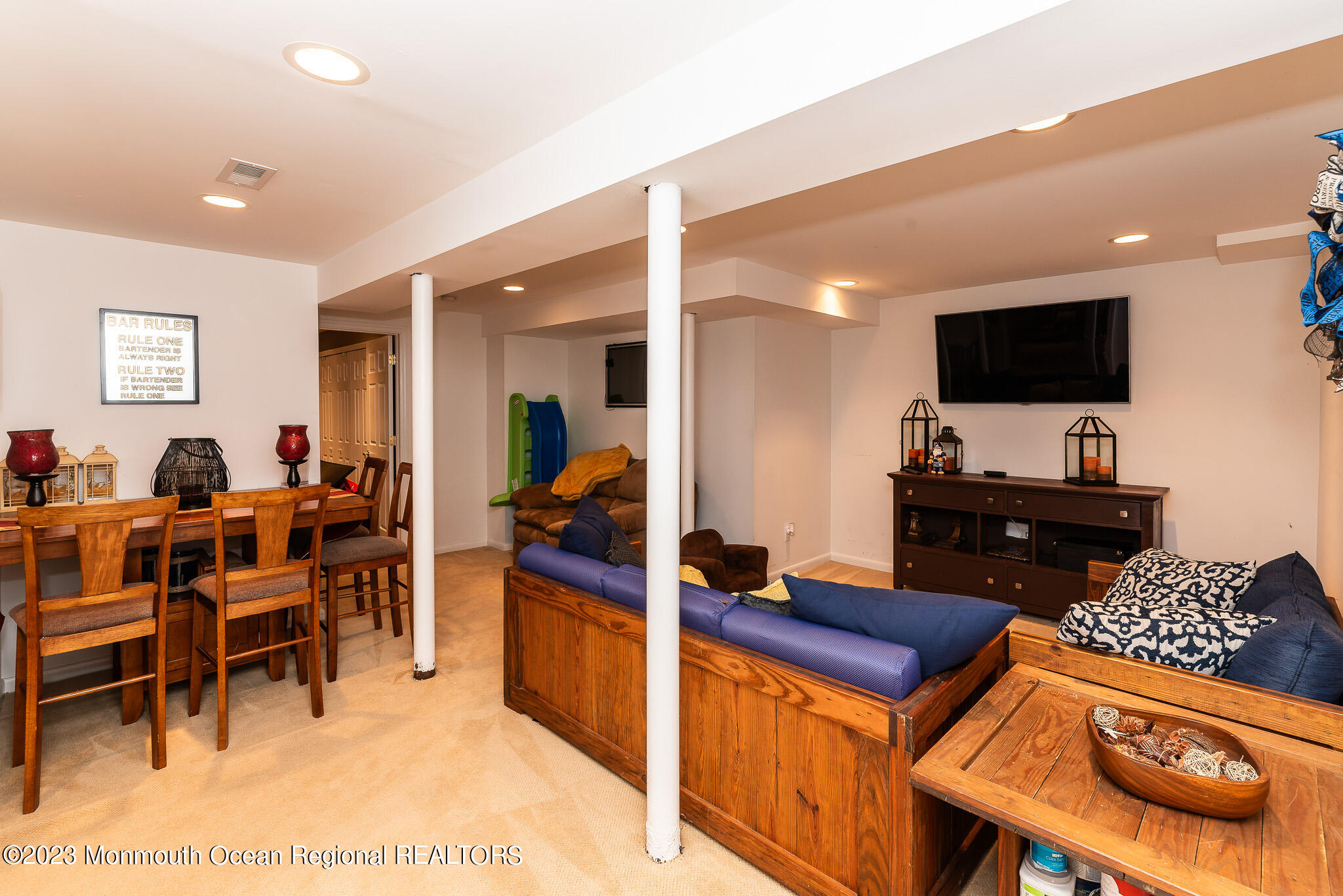 1 Overlook Place Bayville, NJ 08721 - Photo 38 of 66 a living room with furniture a flat screen tv and kitchen view