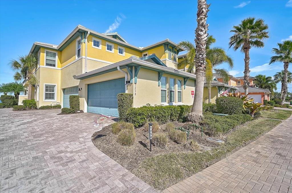 1258 Riverscape Street, Unit A Bradenton, FL 34208 - Photo 13 of 63 a front view of a house with a yard and garage