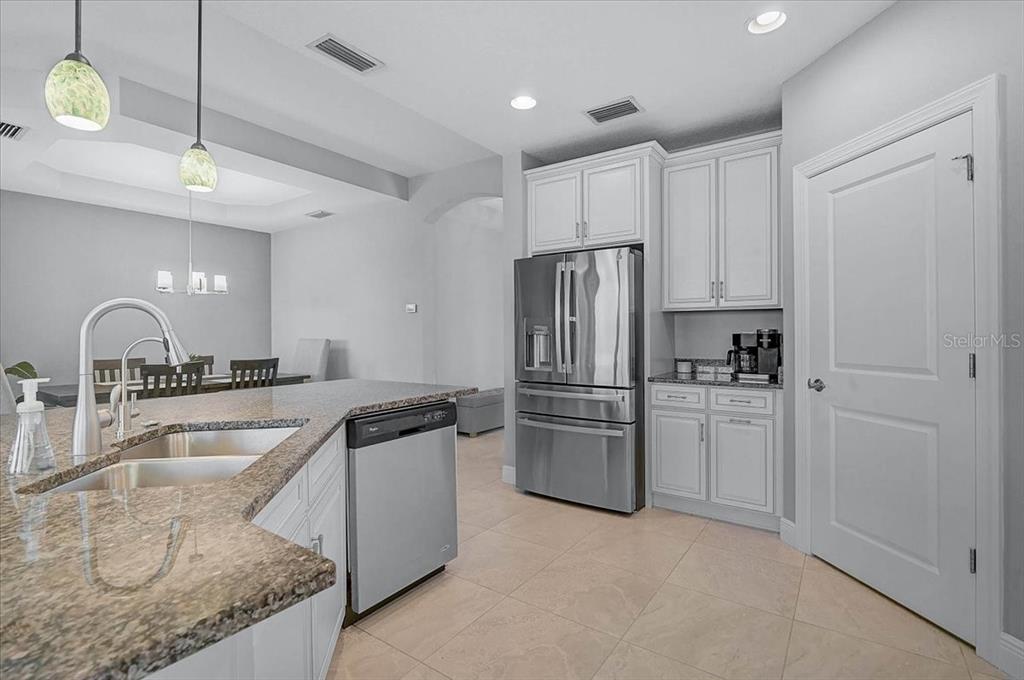 1258 Riverscape Street, Unit A Bradenton, FL 34208 - Photo 17 of 63 a kitchen with stainless steel appliances granite countertop a refrigerator a sink and white cabinets