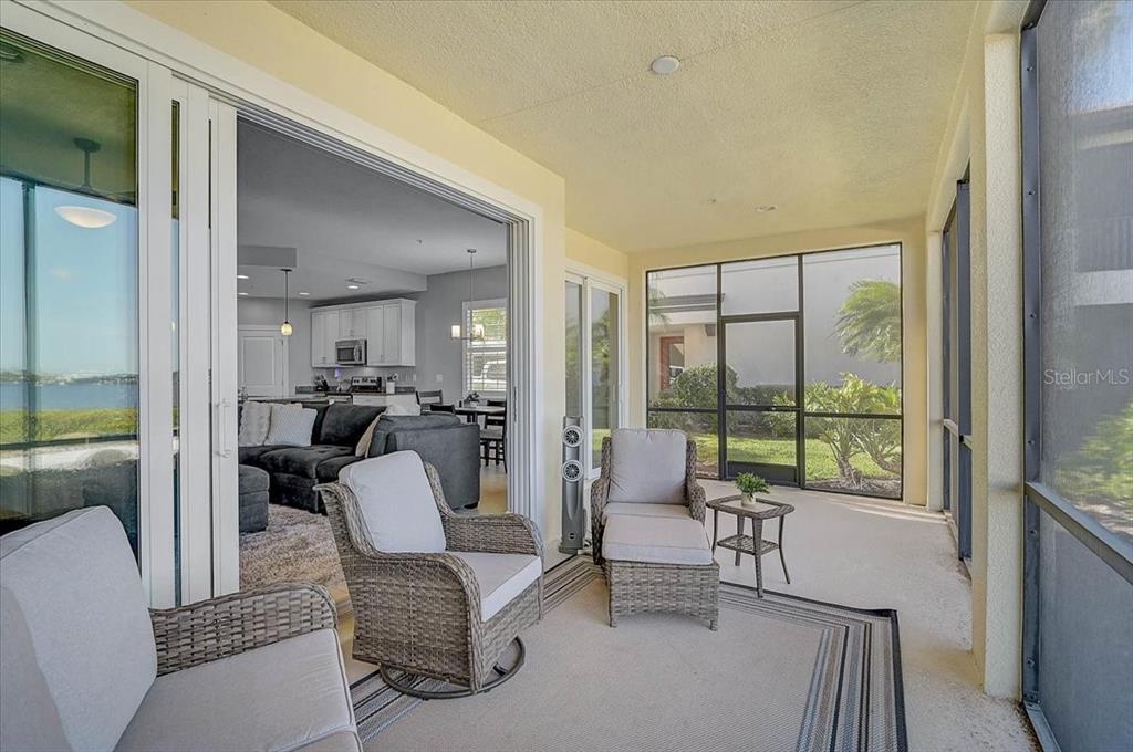 1258 Riverscape Street, Unit A Bradenton, FL 34208 - Photo 22 of 63 a living room with furniture and a floor to ceiling window