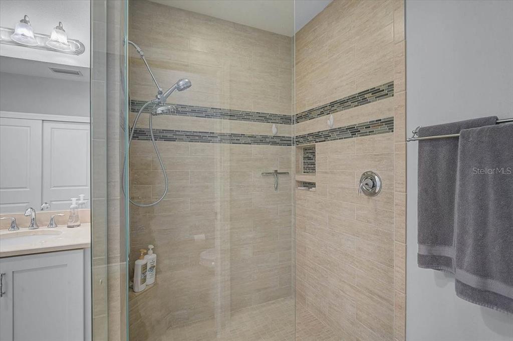 1258 Riverscape Street, Unit A Bradenton, FL 34208 - Photo 27 of 63 a bathroom with a glass shower door