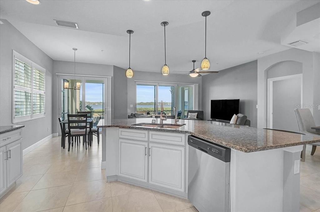 1258 Riverscape Street, Unit A Bradenton, FL 34208 - Photo 6 of 63 a kitchen with sink cabinets and dining table
