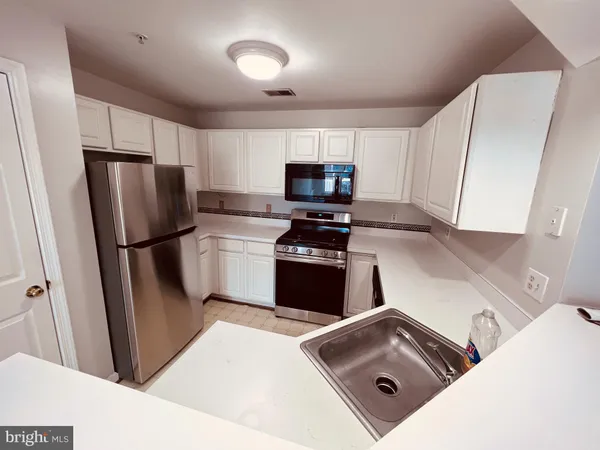 a kitchen with a refrigerator sink and microwave