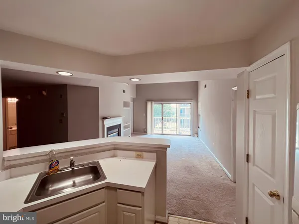 a view of a kitchen with a sink and a window