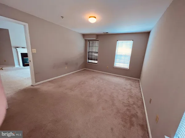 an empty room with windows and closet