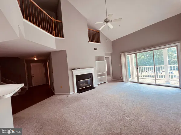 a view of a livingroom with an empty space and a fireplace