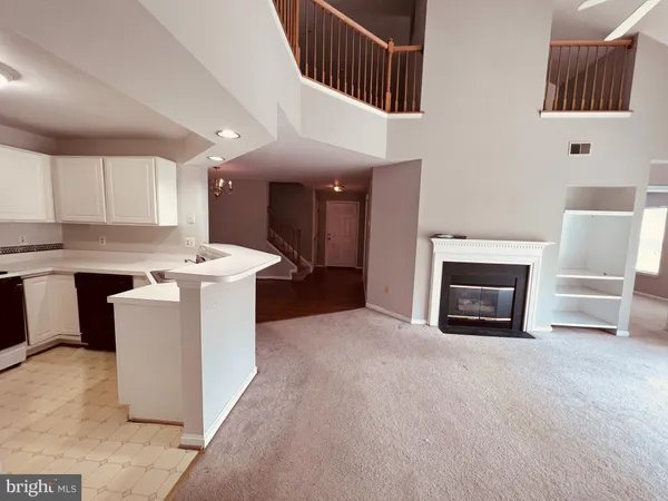 a view of kitchen with granite countertop cabinets and white appliances