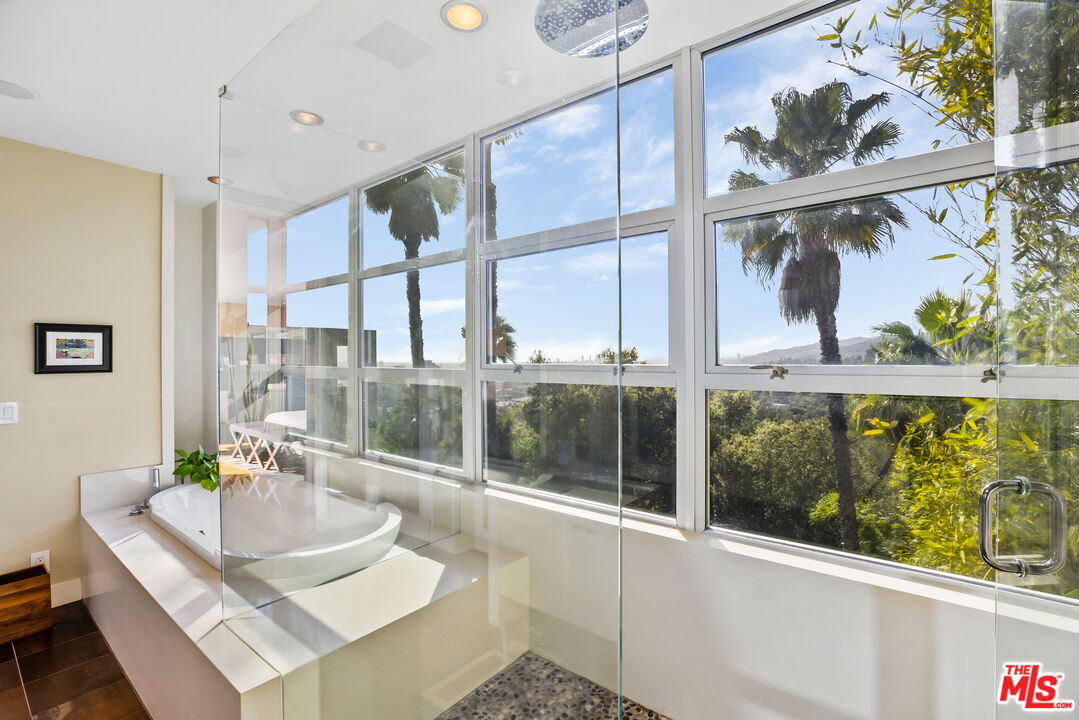 5693 Holly Oak Drive Los Angeles, CA 90068 - Photo 12 of 26 a view of a living room with a floor to ceiling window and wooden floor