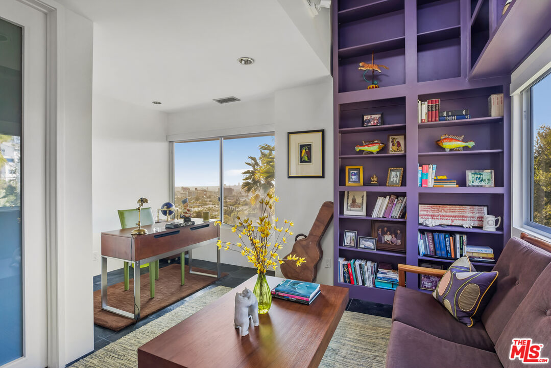 5693 Holly Oak Drive Los Angeles, CA 90068 - Photo 14 of 26 a living room with furniture and a book shelf
