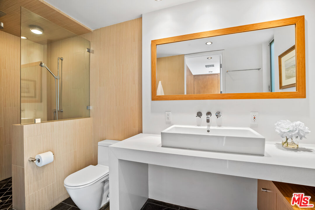 5693 Holly Oak Drive Los Angeles, CA 90068 - Photo 16 of 26 a bathroom with a sink a toilet and a mirror
