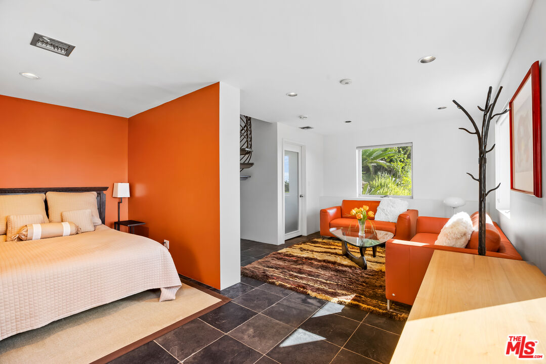 5693 Holly Oak Drive Los Angeles, CA 90068 - Photo 17 of 26 a bedroom with a bed and wooden floor