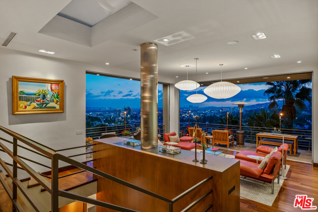 5693 Holly Oak Drive Los Angeles, CA 90068 - Photo 19 of 26 a living room with lots of furniture and a projector screen