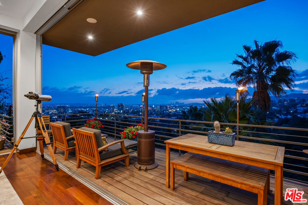 5693 Holly Oak Drive Los Angeles, CA 90068 - Photo 21 of 26 a view of a roof deck with couches and wooden floor