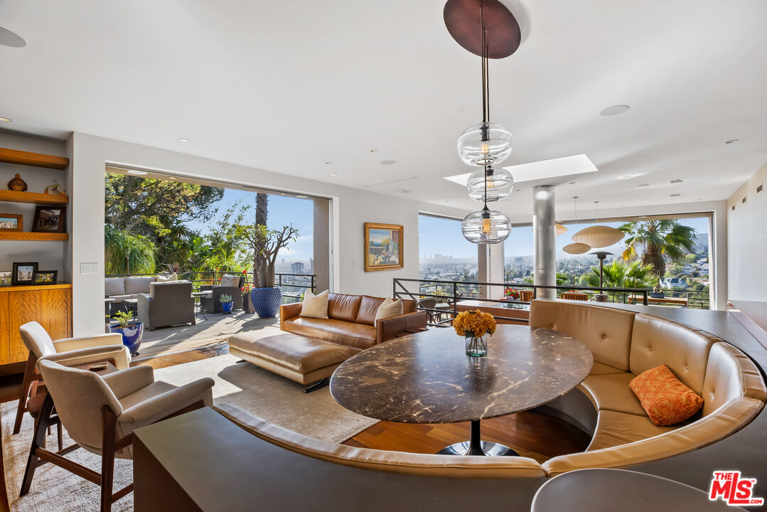 5693 Holly Oak Drive Los Angeles, CA 90068 - Photo 5 of 26 a living room with dining table furniture and a large window