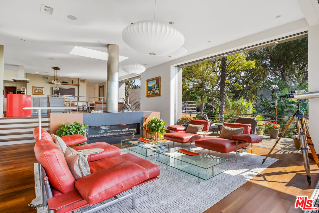 5693 Holly Oak Drive Los Angeles, CA 90068 - Photo 7 of 26 a living room with patio furniture and a large window