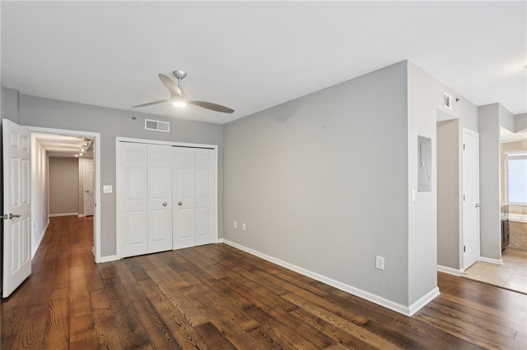 275 13th Street Northeast, Unit 312 Atlanta, GA 30309 - Photo 11 of 31 a view of an empty room with wooden floor and a window