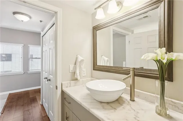 a bathroom with a granite countertop sink and mirror