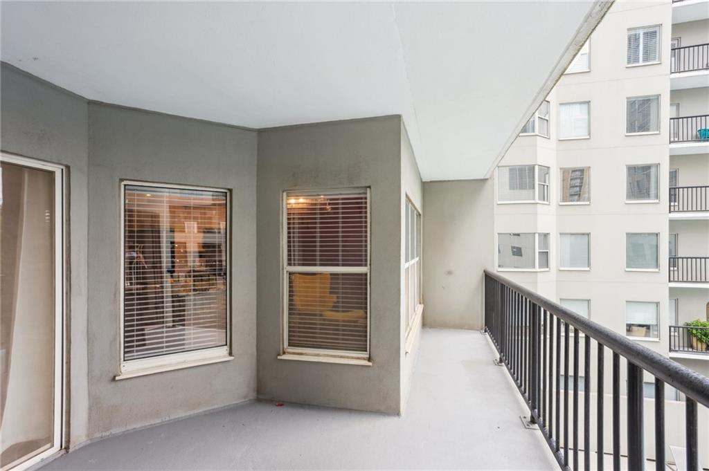 275 13th Street Northeast, Unit 312 Atlanta, GA 30309 - Photo 19 of 31 a view of an empty room with wooden floor and windows