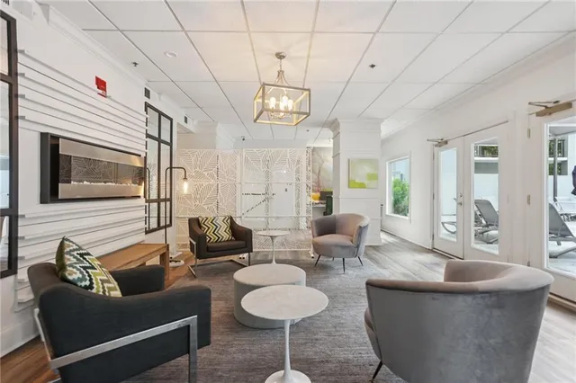 a living room with furniture and a chandelier